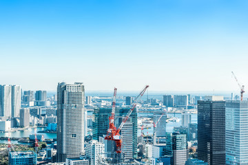 Fototapeta na wymiar Asia Business concept for real estate and corporate construction - panoramic modern city skyline bird eye aerial view with crane near tokyo tower under bright sun and vivid blue sky in Tokyo, Japan