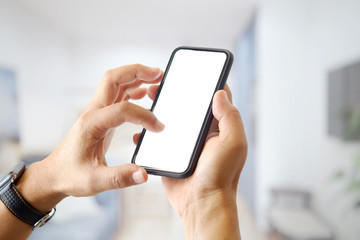 Closeup shot of an unidentifiable man using a smartphone at office background. Blank screen for graphic display montage