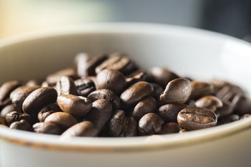 Cup with whole coffee beans