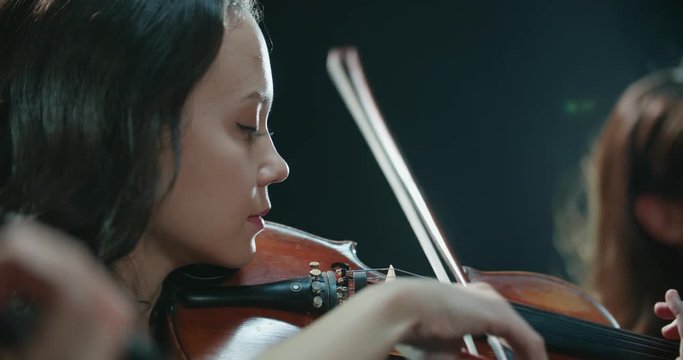 symphony orchestra performance, close-up of stringed instruments at work