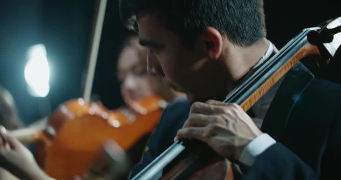 string quartet performs on stage, close-up of a cellist playing
