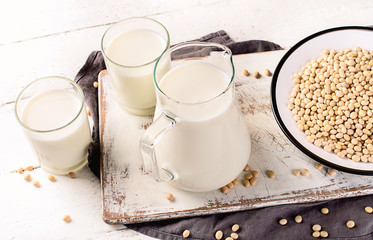 Soymilk and soybean on wooden table.