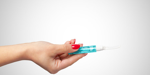 Woman hand with mascara cosmetic tube isolated on color background