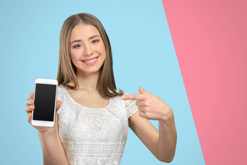 Happy pretty woman showing a blank smart phone screen