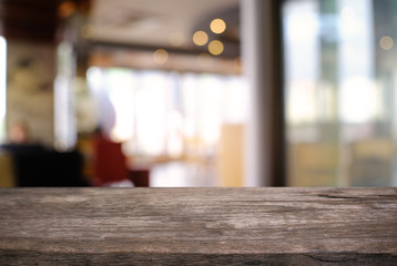 Empty wooden table in front of abstract blurred background of coffee shop . can be used for display or montage your products.Mock up for display of product.