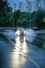 Car on the dark rainy enening street in Moscow, Russia