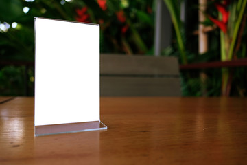 Mock up Menu frame standing on wood table in Bar restaurant cafe. space for text.