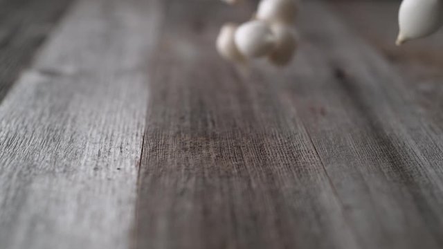 Onions falling and rolling on a table. Shot with high speed camera, phantom flex 4K. Slow Motion.