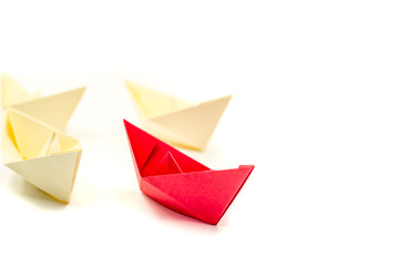 origami paper ship is followed by other ships.leadership business concept