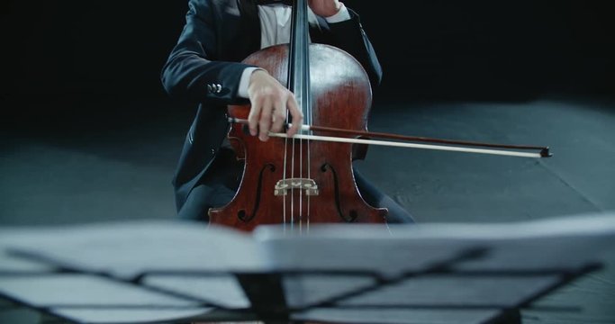asian cellist male solo classical music performance, close-up