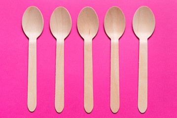 Lot of wooden spoons on colorful background
