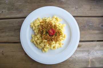 Käsespätzle or Traditional Homemade Egg Noodles with Cheese Served in Southern Germany