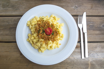 Käsespätzle or Traditional Homemade Egg Noodles with Cheese Served in Southern Germany