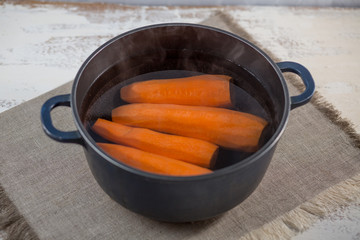 Vegetable orange boiled carrots on a table. Seasoning, spices.