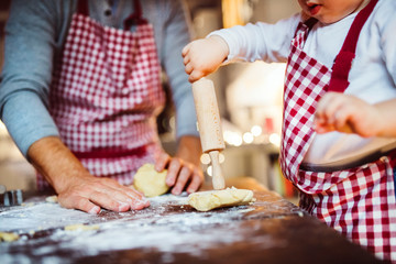 Young family making cookies at home.