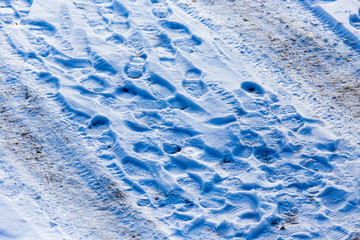 Footprints from shoes on snow as background