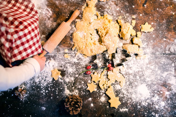 Toddler making gingerbread cookies at home.