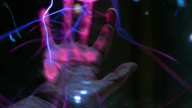 Abstract lightning in a plasma balloon. Scanning the hand and fingerprint. The system of fingerprint security. Transmission of electricity by air, wireless transmission of electricity