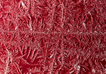 Snowflake on a red fence as a background