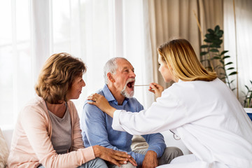 Fototapeta premium Female doctor examining a senior man.