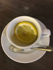 White porcelain cup with a slice of lemon