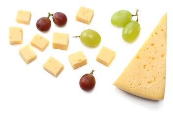 piece of cheese with grapes isolated on white background