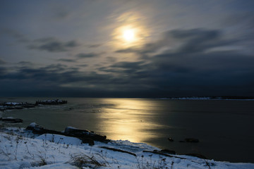 Fototapeta na wymiar Moon at night in winter. White Sea in Rabocheostrovsk, Kem, Russia