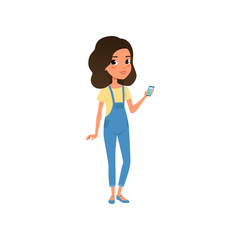 Cute teenager character dressed in yellow t-shirt and blue denim overall. Cartoon girl with smartphone in hand. Stylish casual outfit. Colorful flat vector design