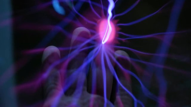 Abstract lightning in a plasma balloon. Scanning the hand and fingerprint. The system of fingerprint security. Transmission of electricity by air, wireless transmission of electricity.