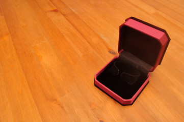 Open velvet jewelry box for bangle on wood