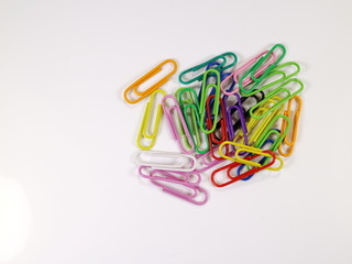 paper clips of different colors on a white background