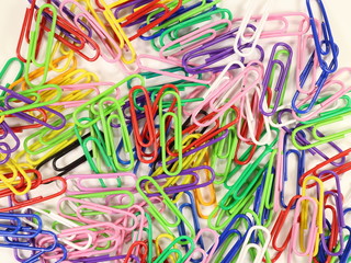 paper clips of different colors on a white background