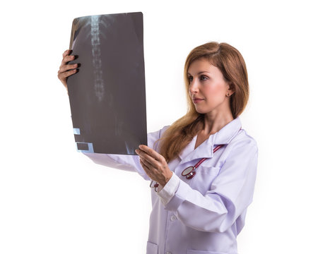 Beautiful caucasian doctor holding and checking the black X-RAY film. Studio shot isolated on white