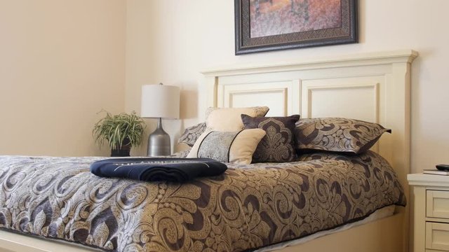 Dolly shot of a beautiful large bed with pillows