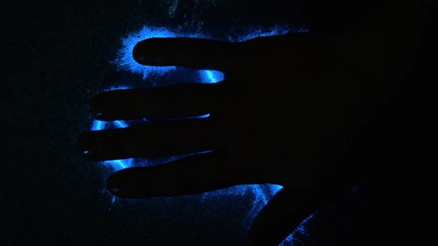 Abstract blue lightning. A man touches his hand to electricity. Aura scan, human electromagnetic field. Scanning the hand and fingerprint