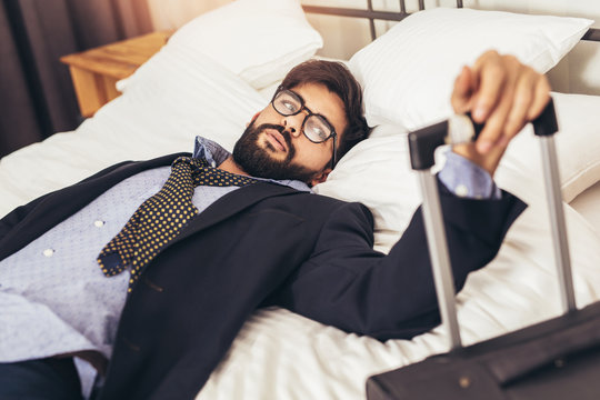 Tired Businessman resting in hotel room