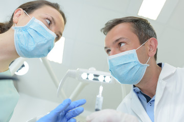 a male dentist and female dental nurse