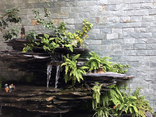 Tree in pot with brick wall background