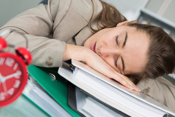 tired businesswoman sleeping on the desk