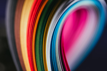 close up of colored bright quilling paper curves on black - obrazy, fototapety, plakaty