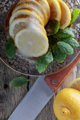 Lemon slices with sugar and mint leaves.