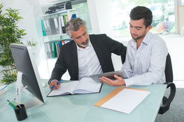 Businessmen sat at desk