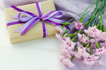 Obraz na płótnie Canvas Present or gift box and delicate flowers