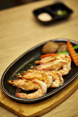 Japanese seafood. Fried spicy shrimps with herbs