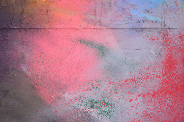 A large fragment of the graffiti pattern applied to the wall with aerosol paint. The gradient between several colors is carried out by spraying the paint. Abstract background image