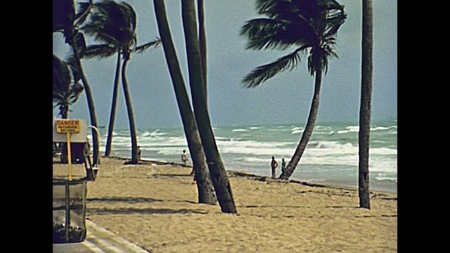 Panorama of the Miami Beach in Florida and its tropical sea, the long white beaches and popular seafront street in 70's with few tourists and buildings. Historical United States of America in 1978.