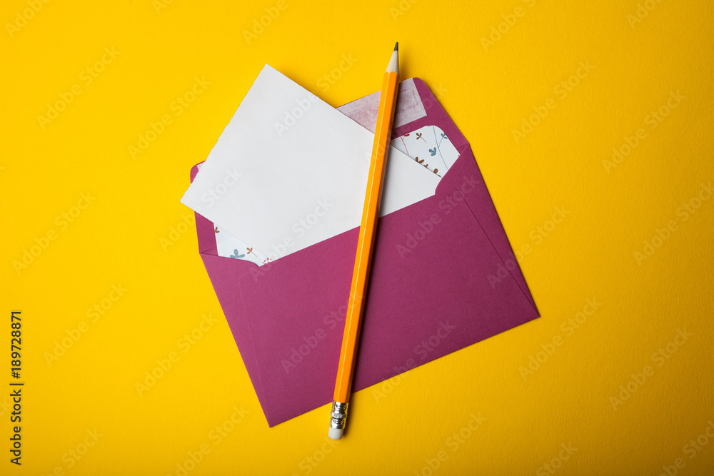 Poster envelope with blank letter comes out on a yellow background with copy space for some text