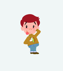 White boy with a unicorn pullover sticks out his tongue in gesture of funny shyness.