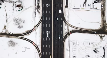 Fototapete Rund Luftbild Aerial view snow-covered road with cars in winter  © Oleksii Nykonchuk