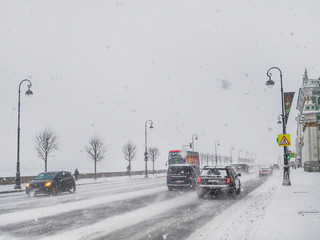 Snow-covered city. City traffic in heavy snowfall.